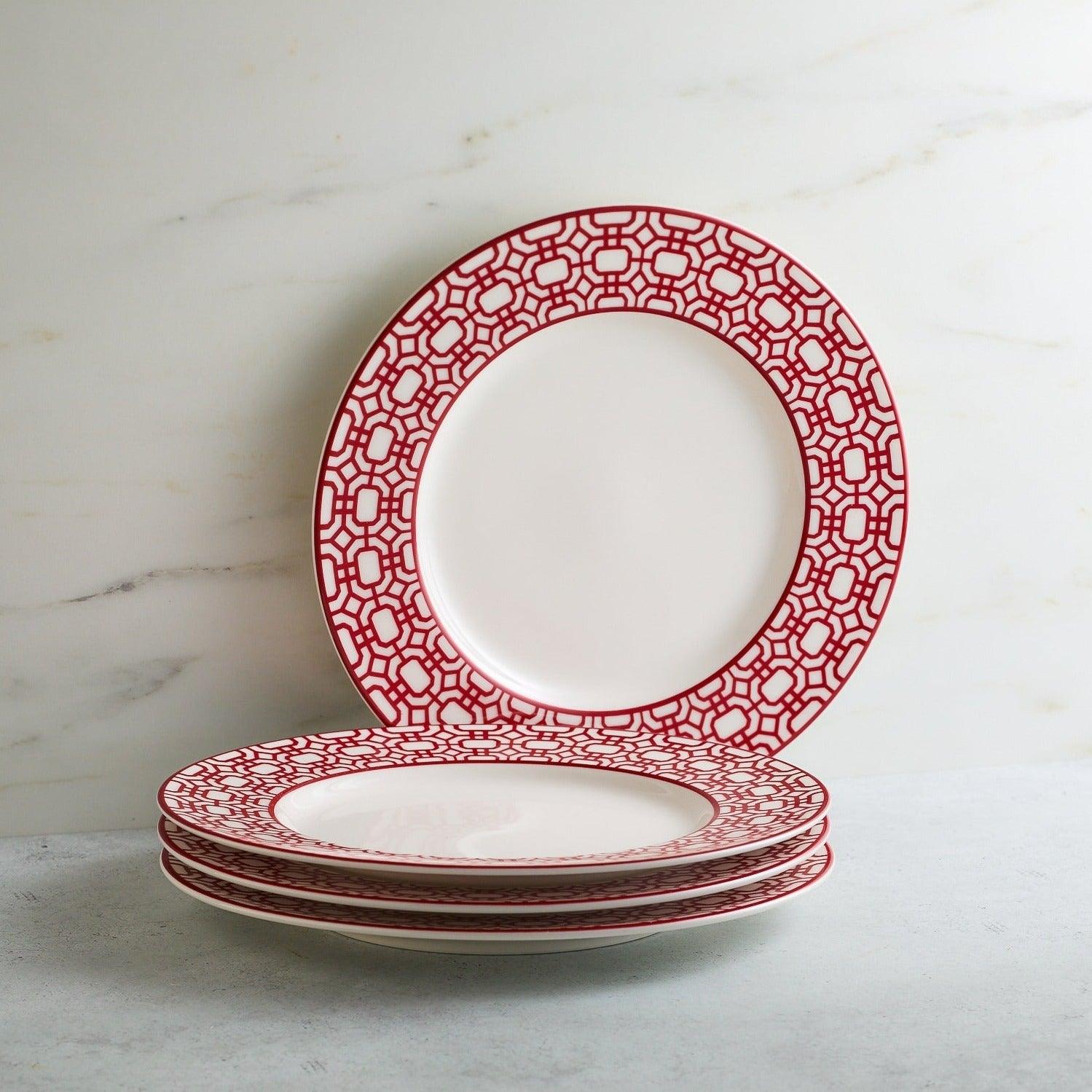 a stack of red and white plates sitting on top of a table