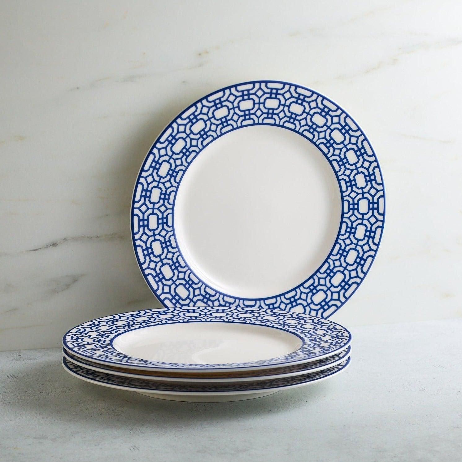 a stack of blue and white plates sitting on top of a table