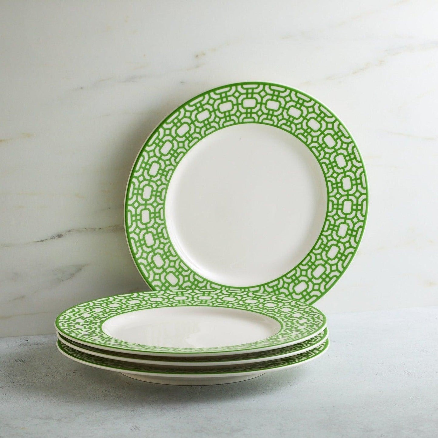 a stack of green and white plates sitting on top of a table