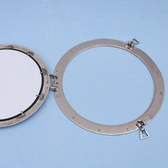 a mirror with a metal frame on a blue background