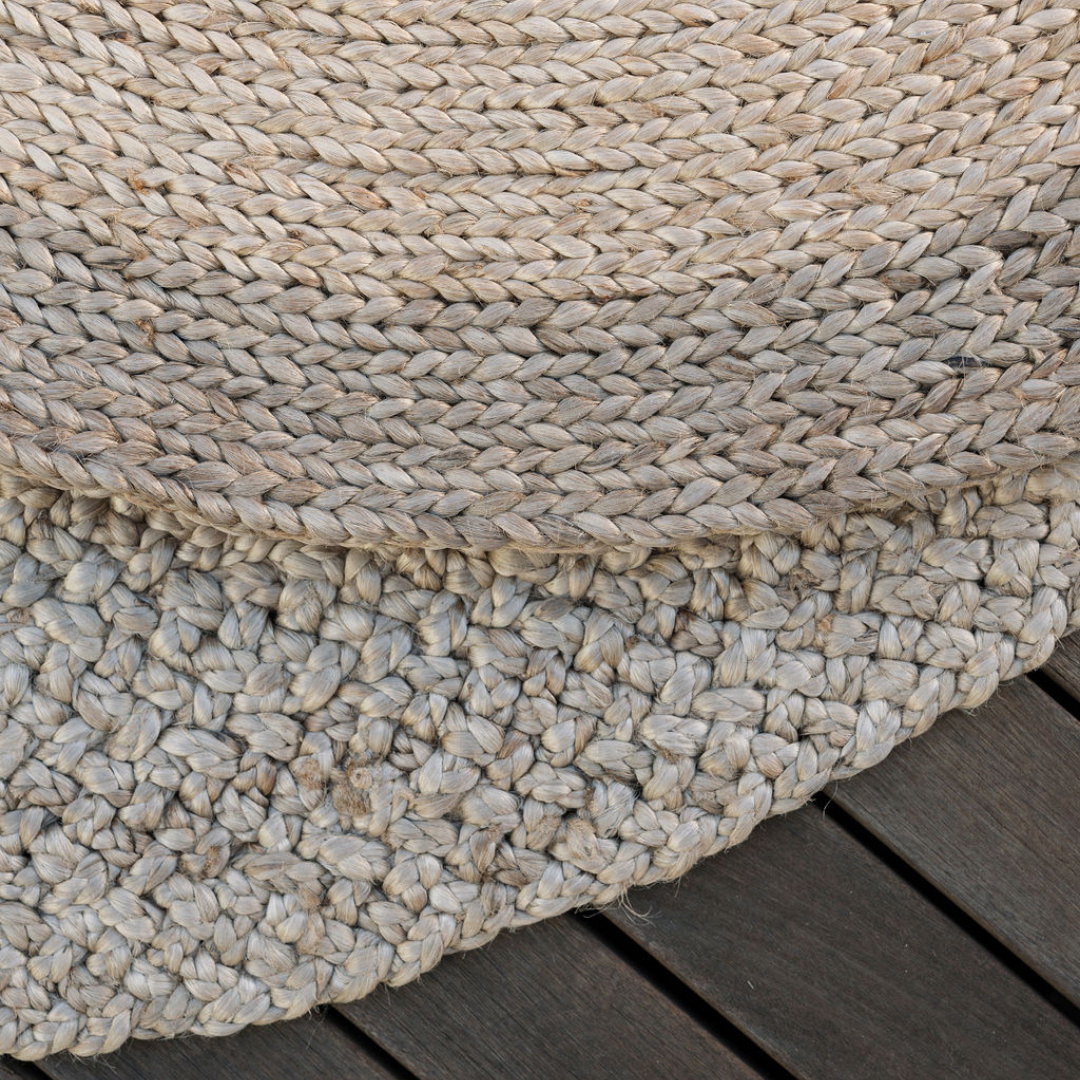 Close-up of braided jute fibers and stitched rows on the natural and brown rug