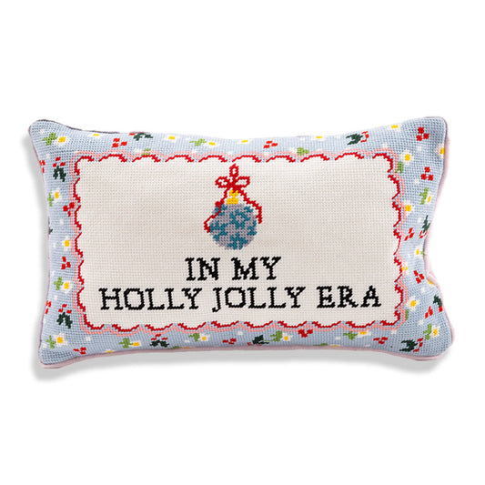 In My Holly Jolly Era needlepoint pillow with black lettering, a blue ornament, red scalloped detailing, and a colorful border