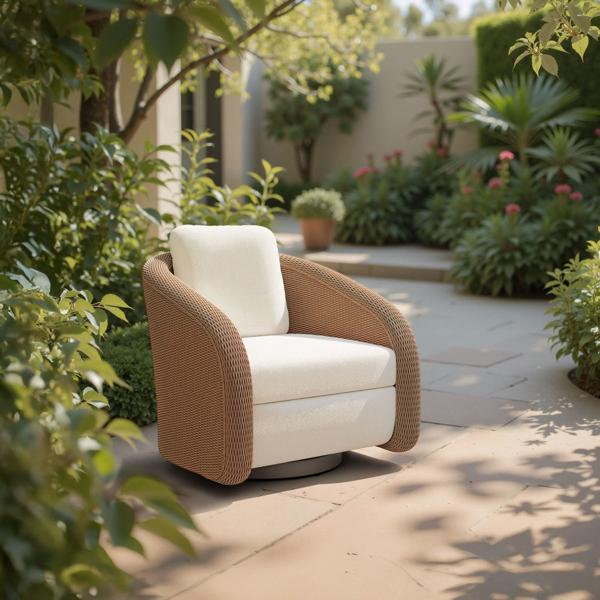 Solara ivory swivel chair styled on a garden patio surrounded by greenery
