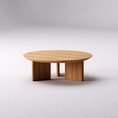 Alternate view of the Noah round oak coffee table showing its broad wood legs
