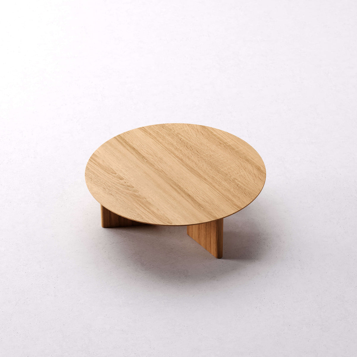 Noah round solid oak coffee table viewed from above at an angle in Clear Oak