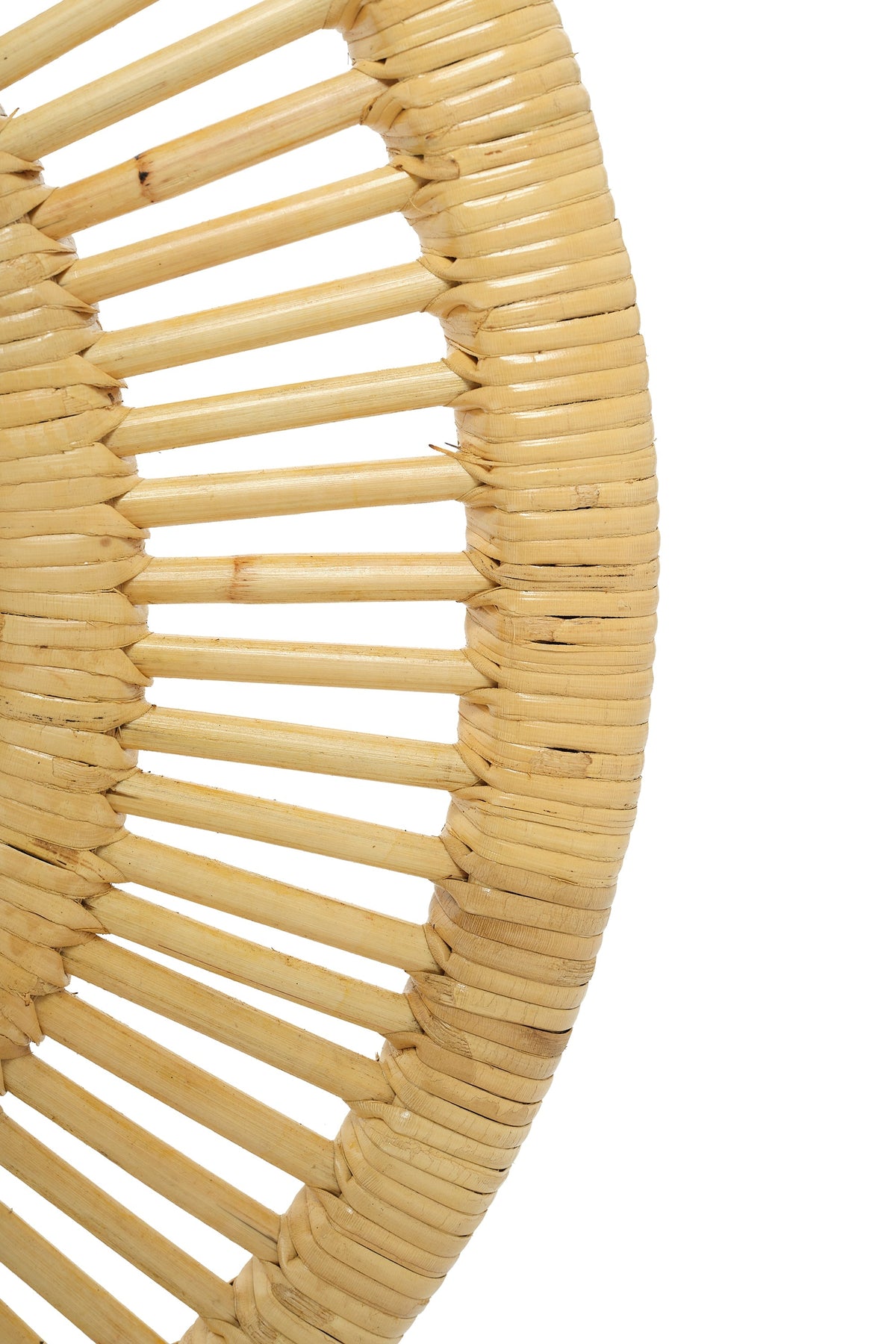 Detail of the rattan-wrapped outer border and cane spokes on the round wall mirror