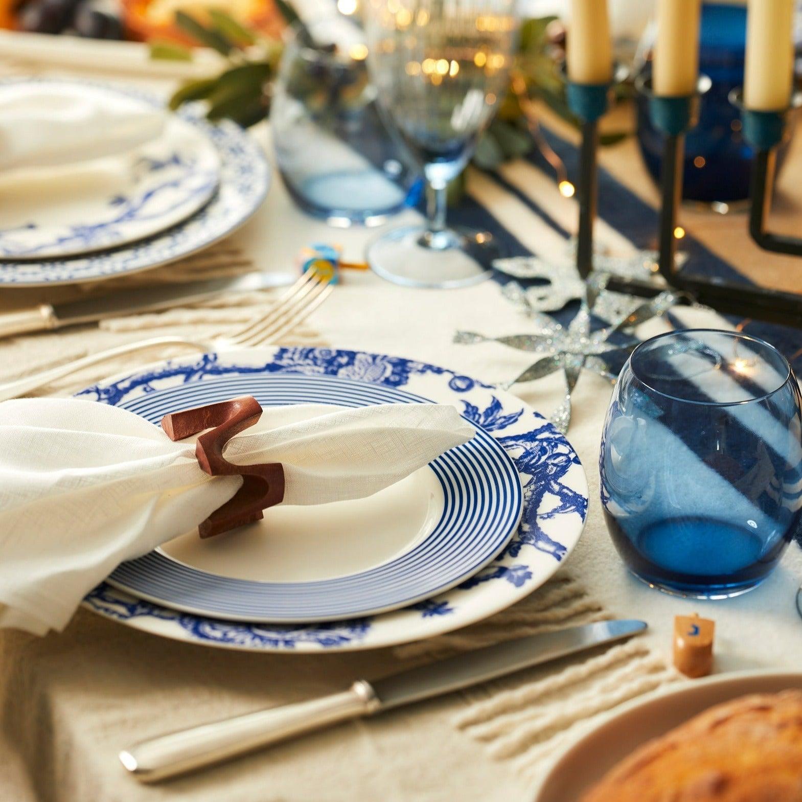 a close up of a table with plates and napkins
