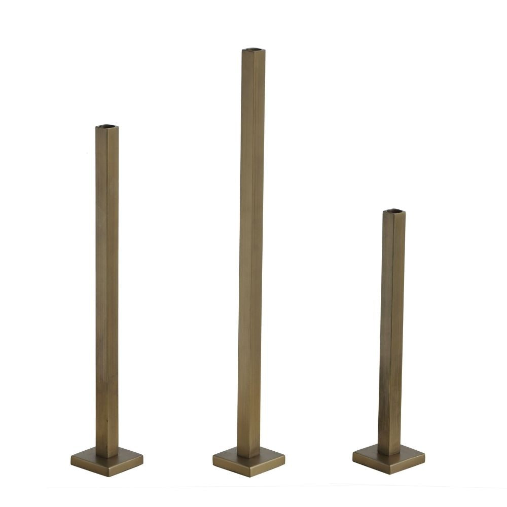Set of three gold-finish iron taper candle holders with square stems and bases on a white background