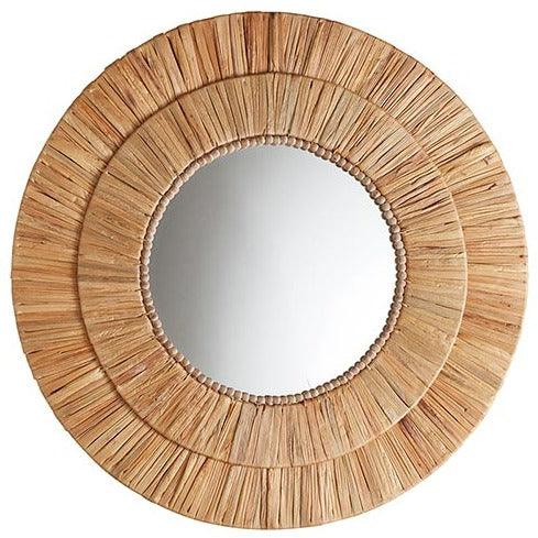 a round mirror made out of bamboo sticks