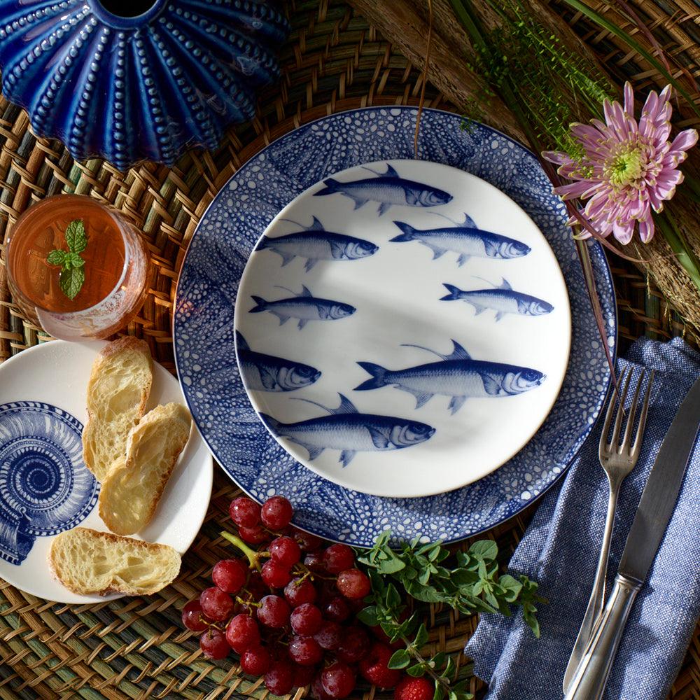 a blue and white plate with fish on it