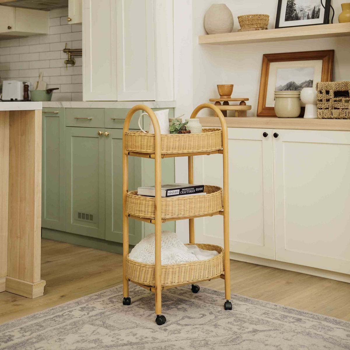 	Natural rattan rolling storage trolley holding tableware and books beside kitchen cabinets