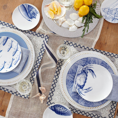 a table set with blue and white plates