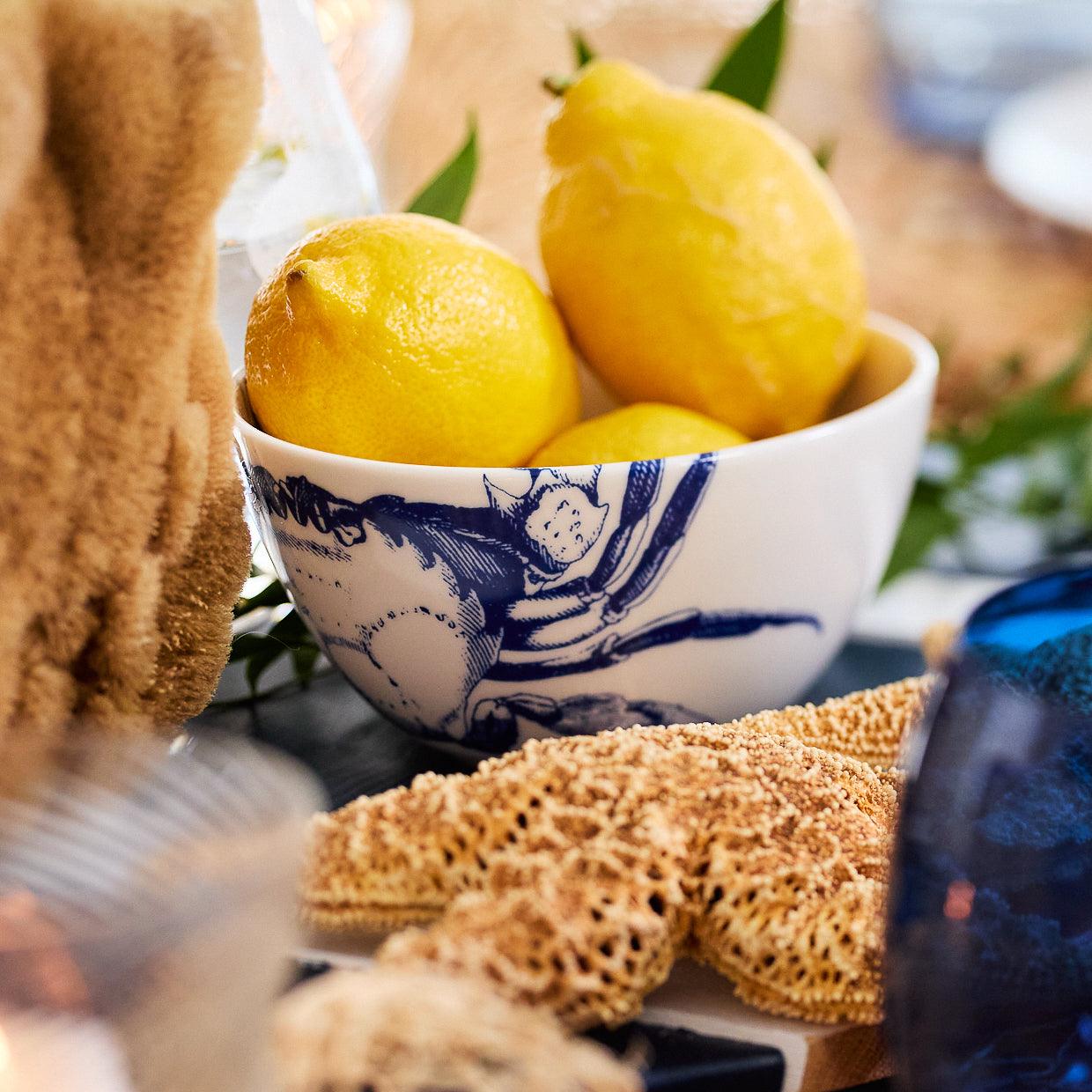 a bowl of lemons on a table