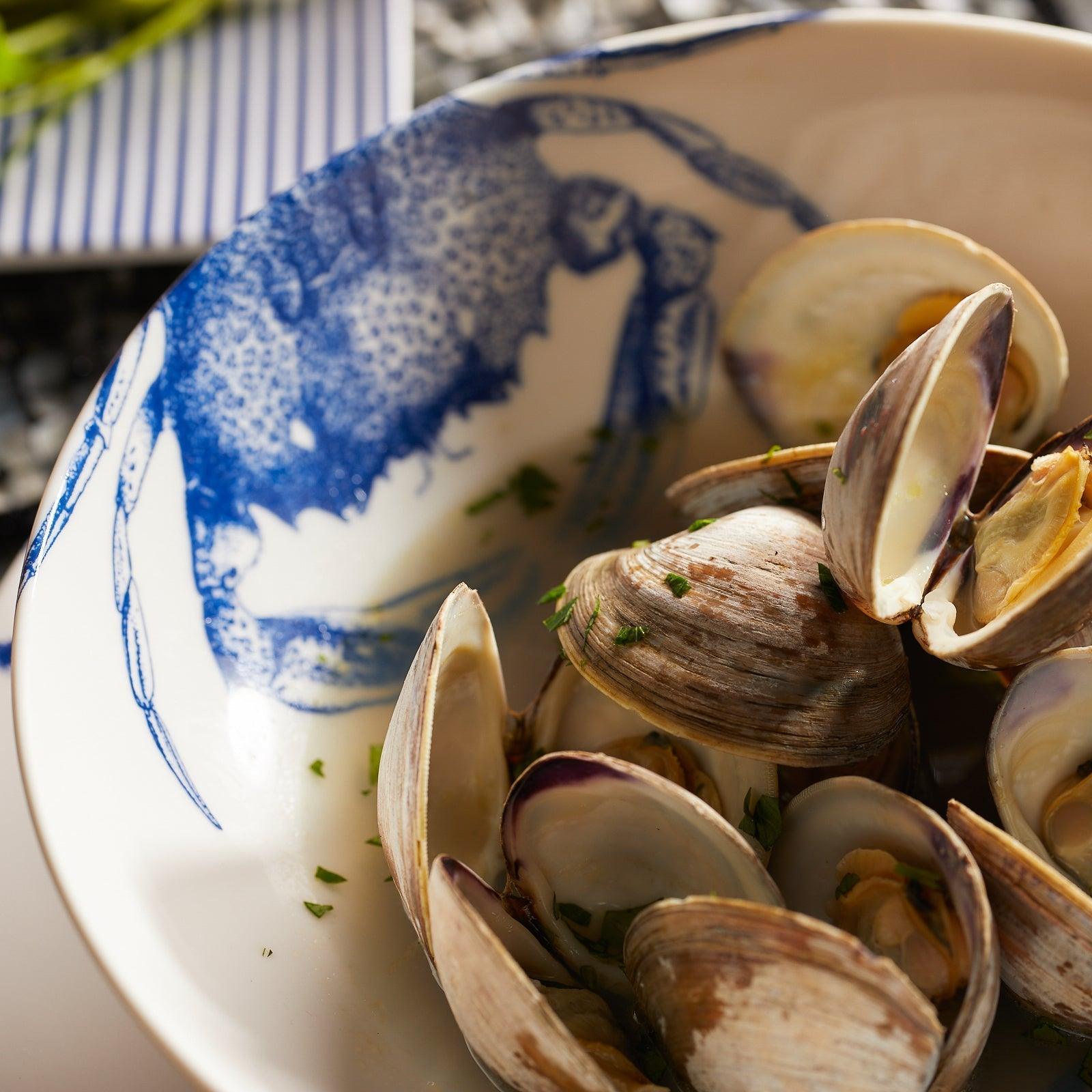 a bowl filled with clams on top of a table