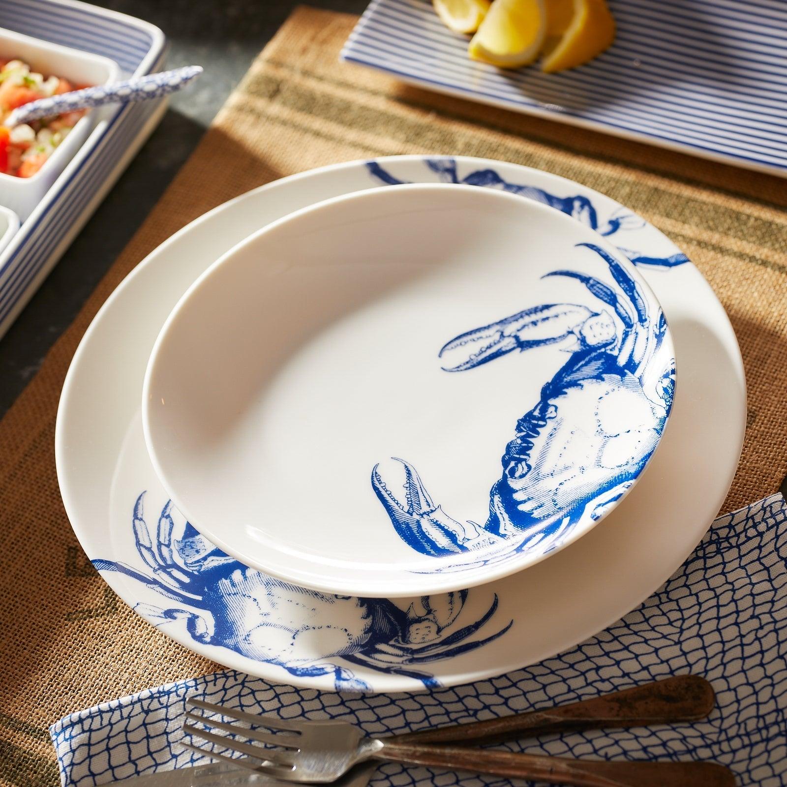 a blue and white plate with a crab on it