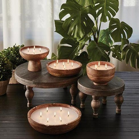 a group of candles sitting on top of a wooden table