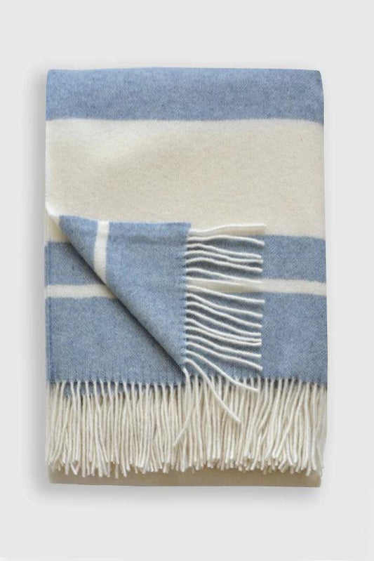 a blue and white blanket with fringes
