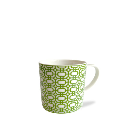 a green and white coffee cup on a white background