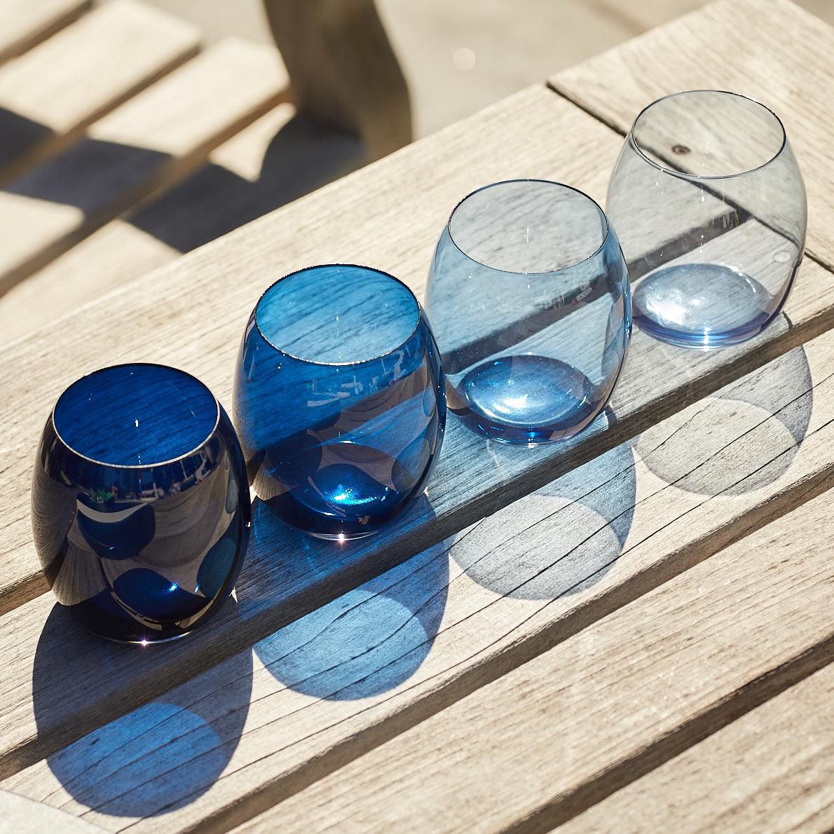 three glasses sitting on top of a wooden table