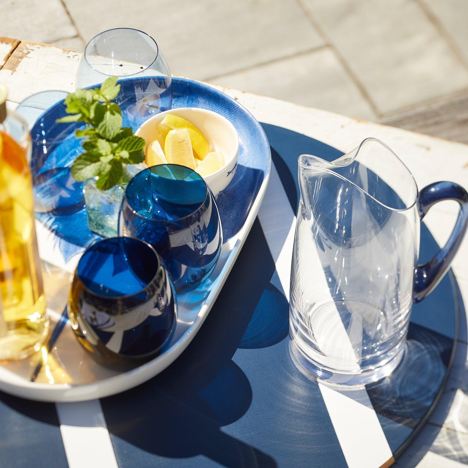 a blue and white plate topped with drinks