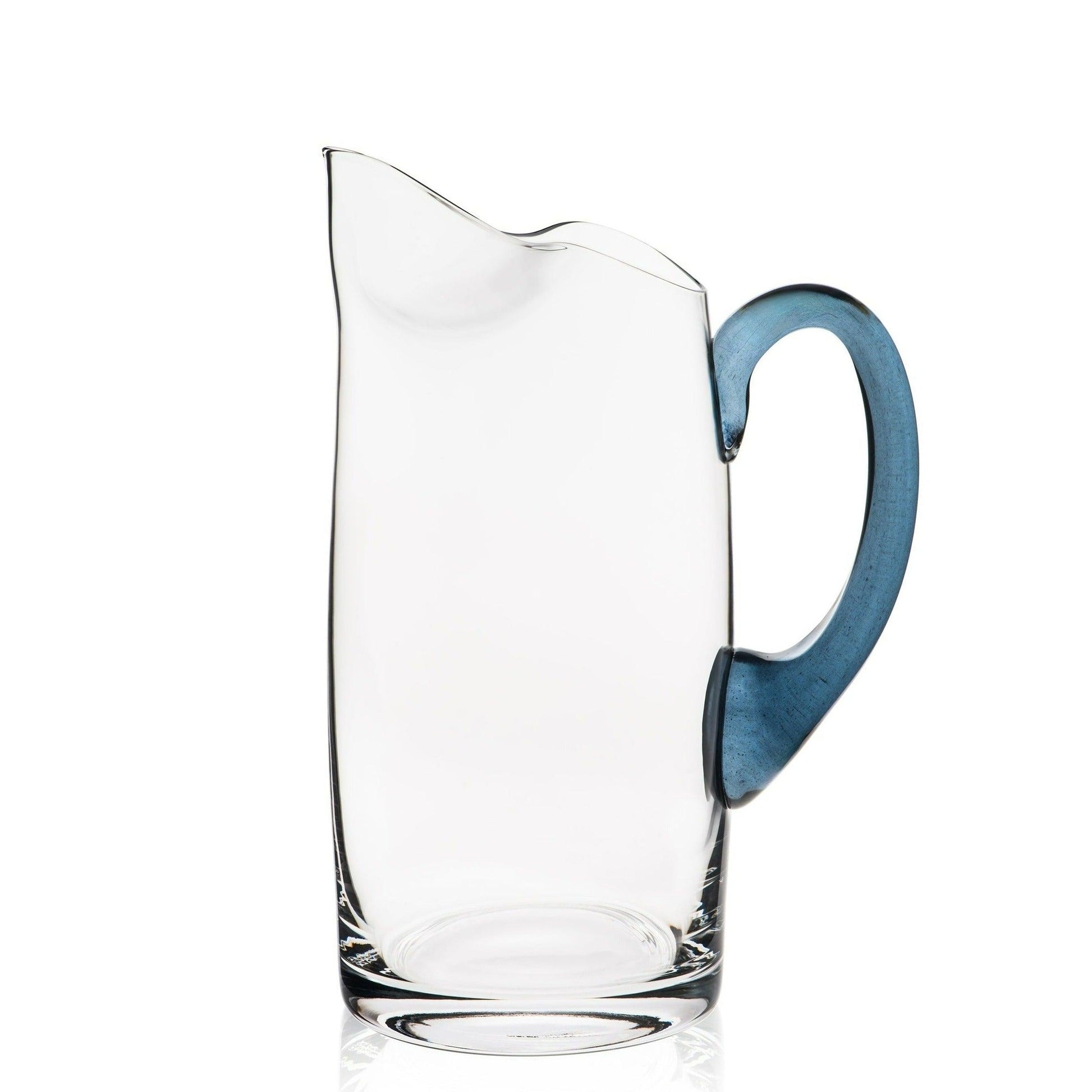 a glass pitcher with a blue handle on a white background