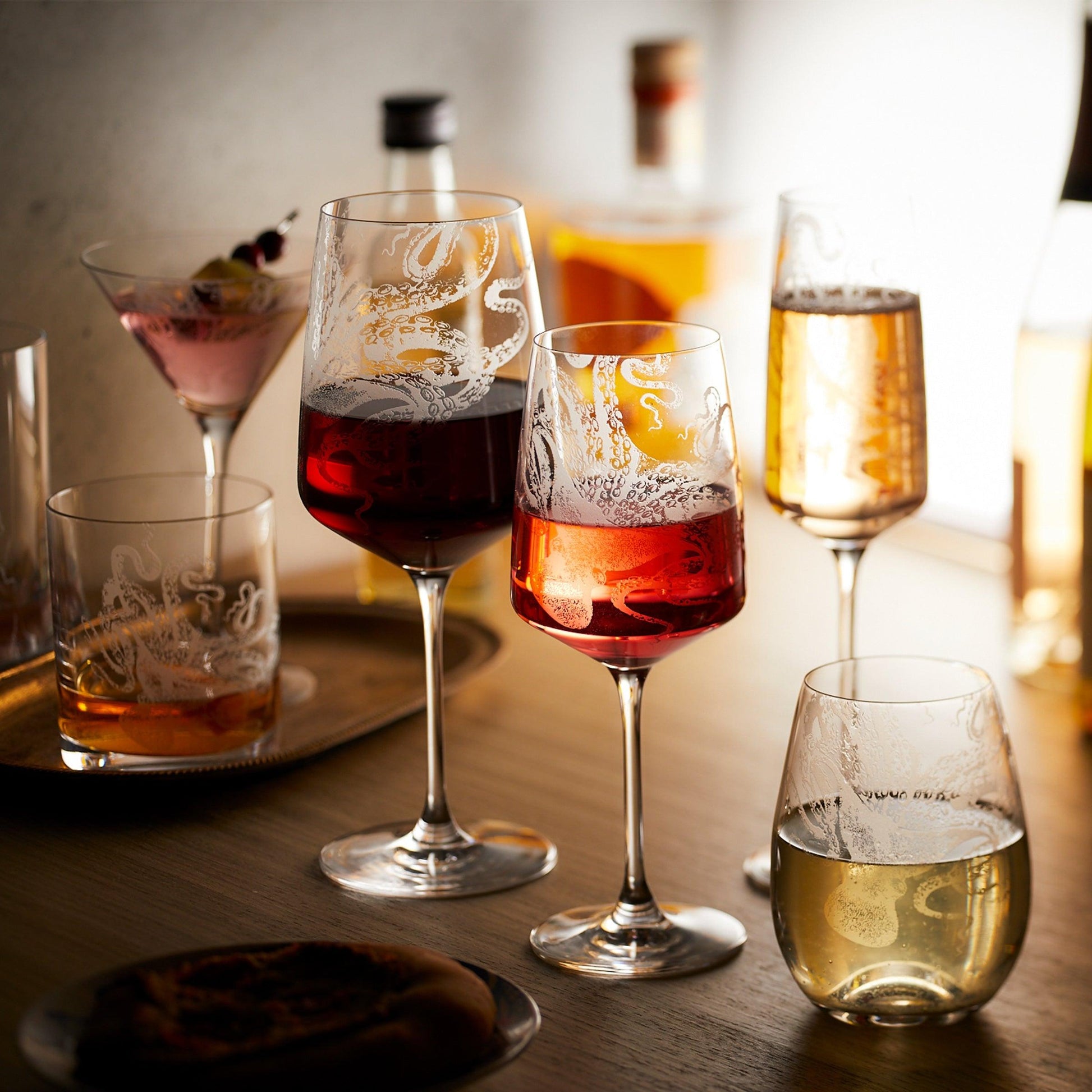 a wooden table topped with three glasses of wine