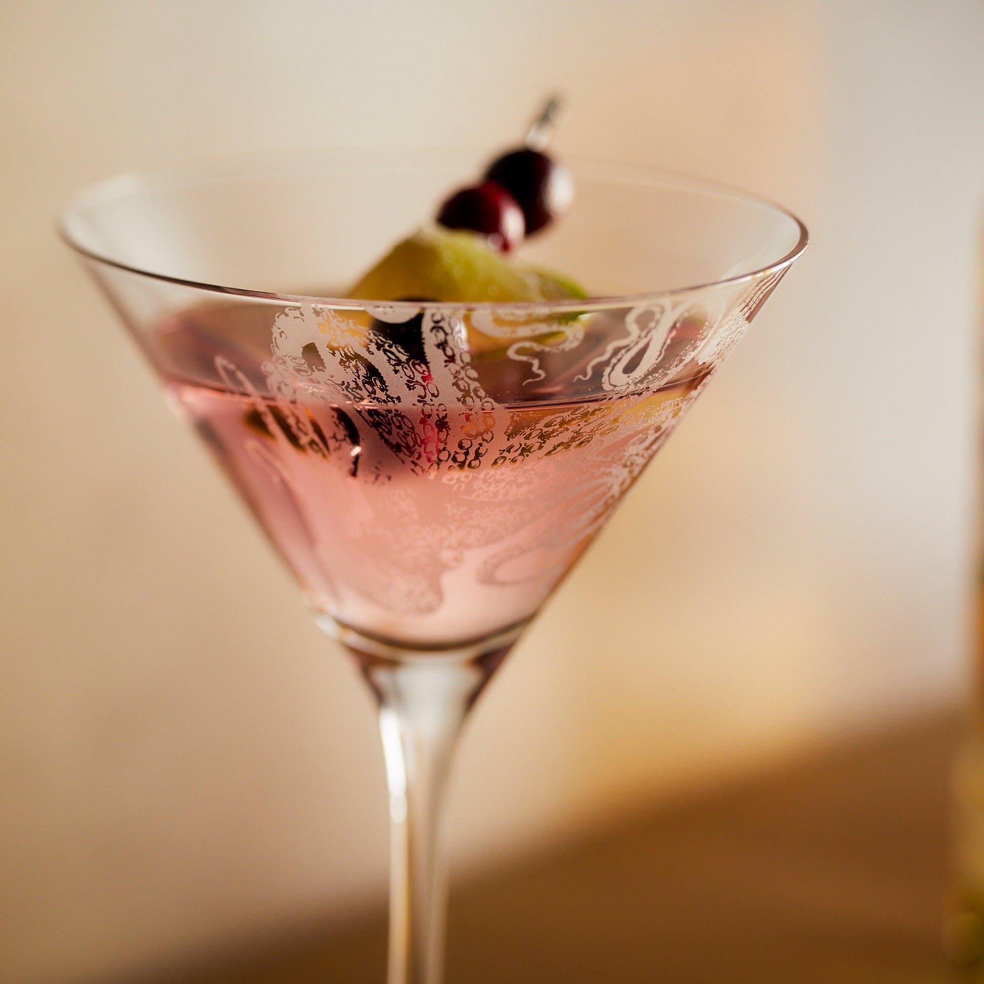 a glass filled with a liquid and a fruit on top of it