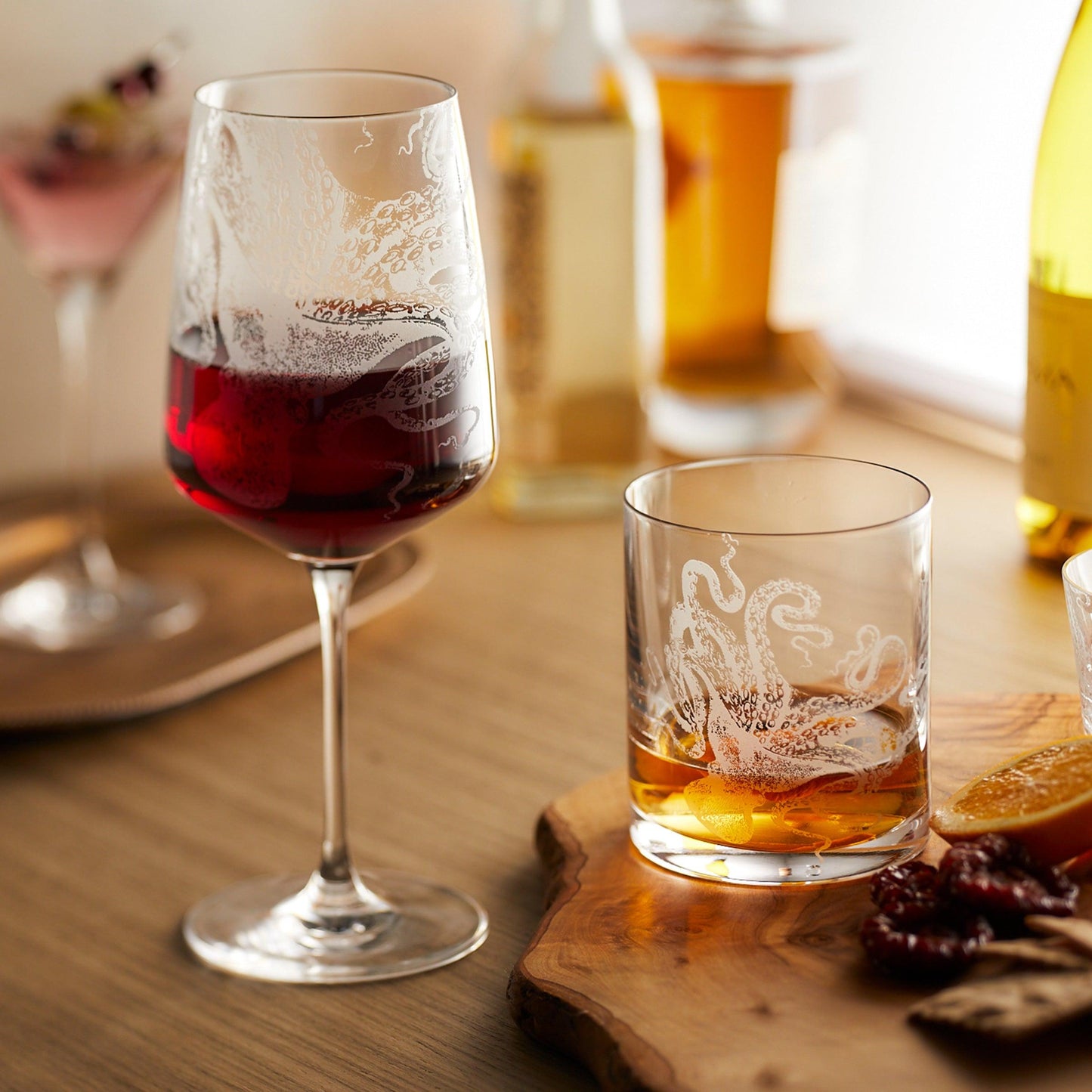 a wooden table topped with two glasses of wine