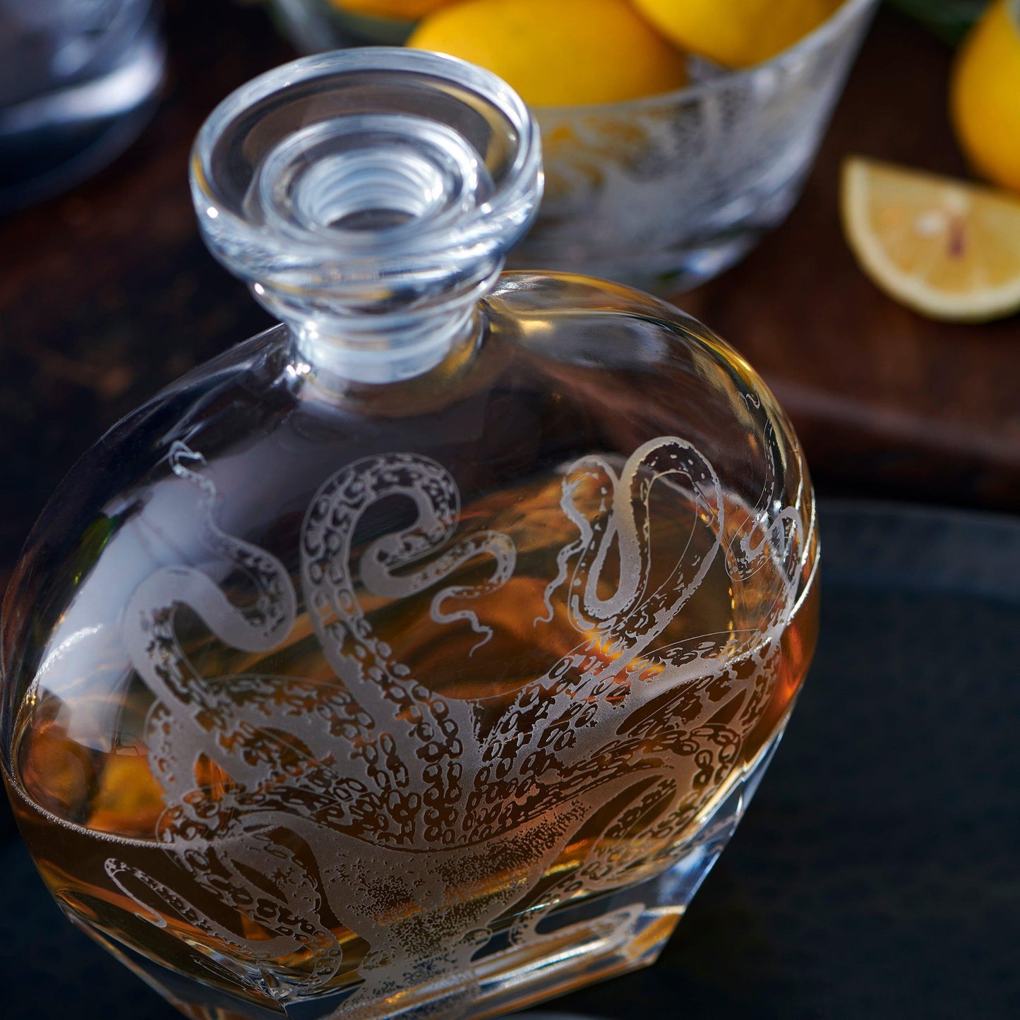 a glass decanter with an octopus on it