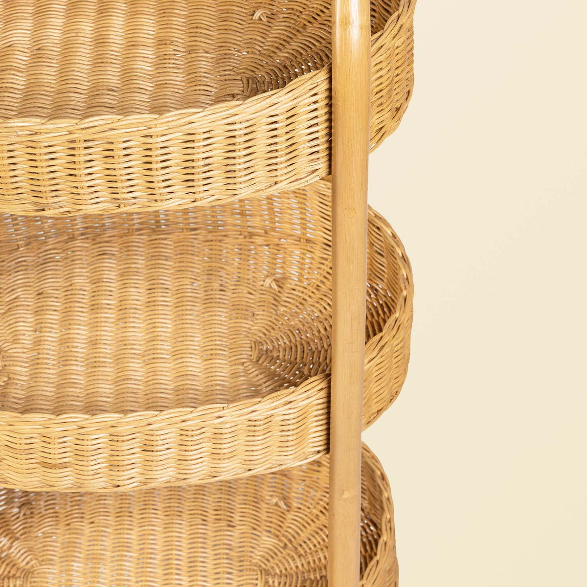 	Overhead angled view of the trolley’s oval woven basket trays and rattan handles