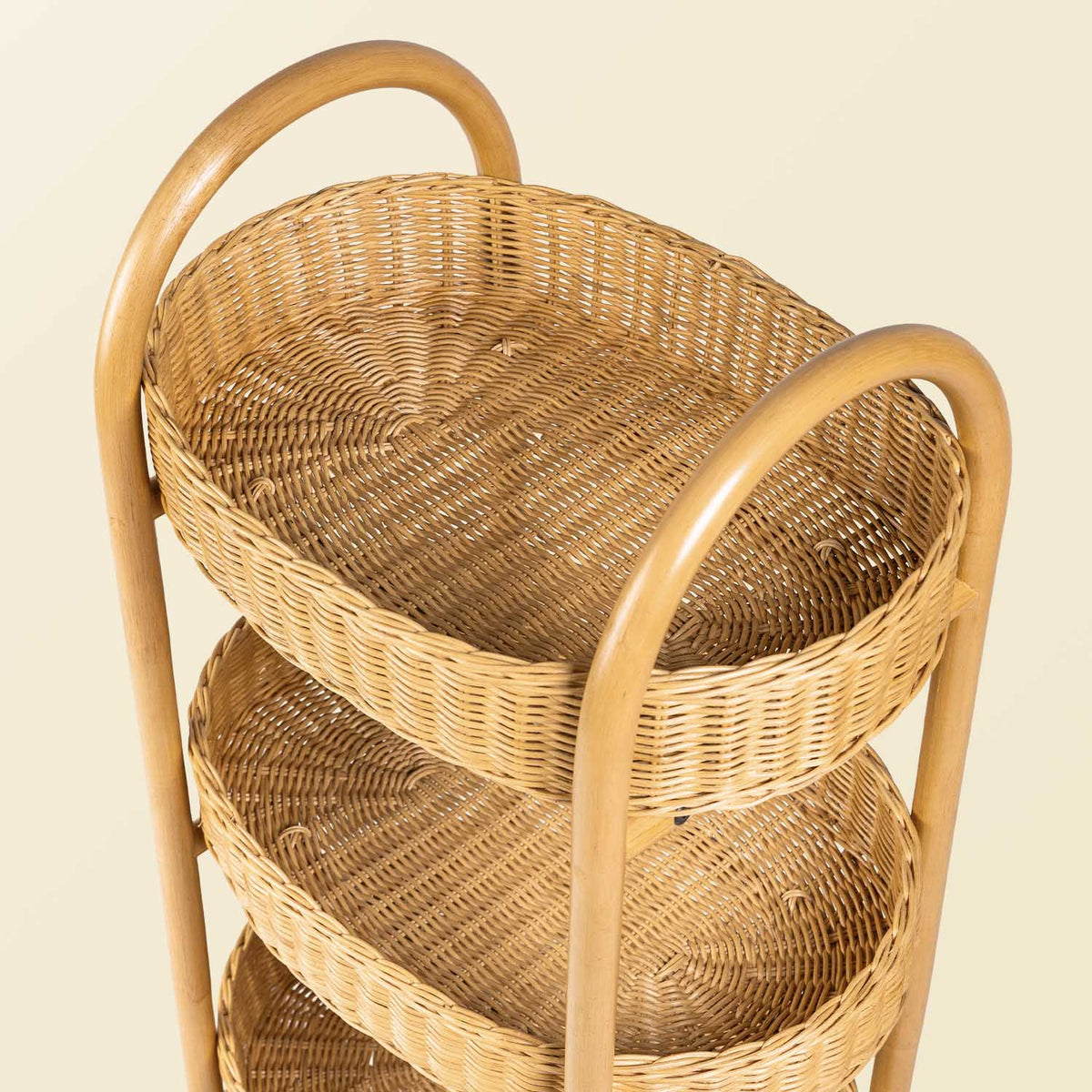 	Close-up of the rattan frame and woven sides of the trolley’s basket tiers