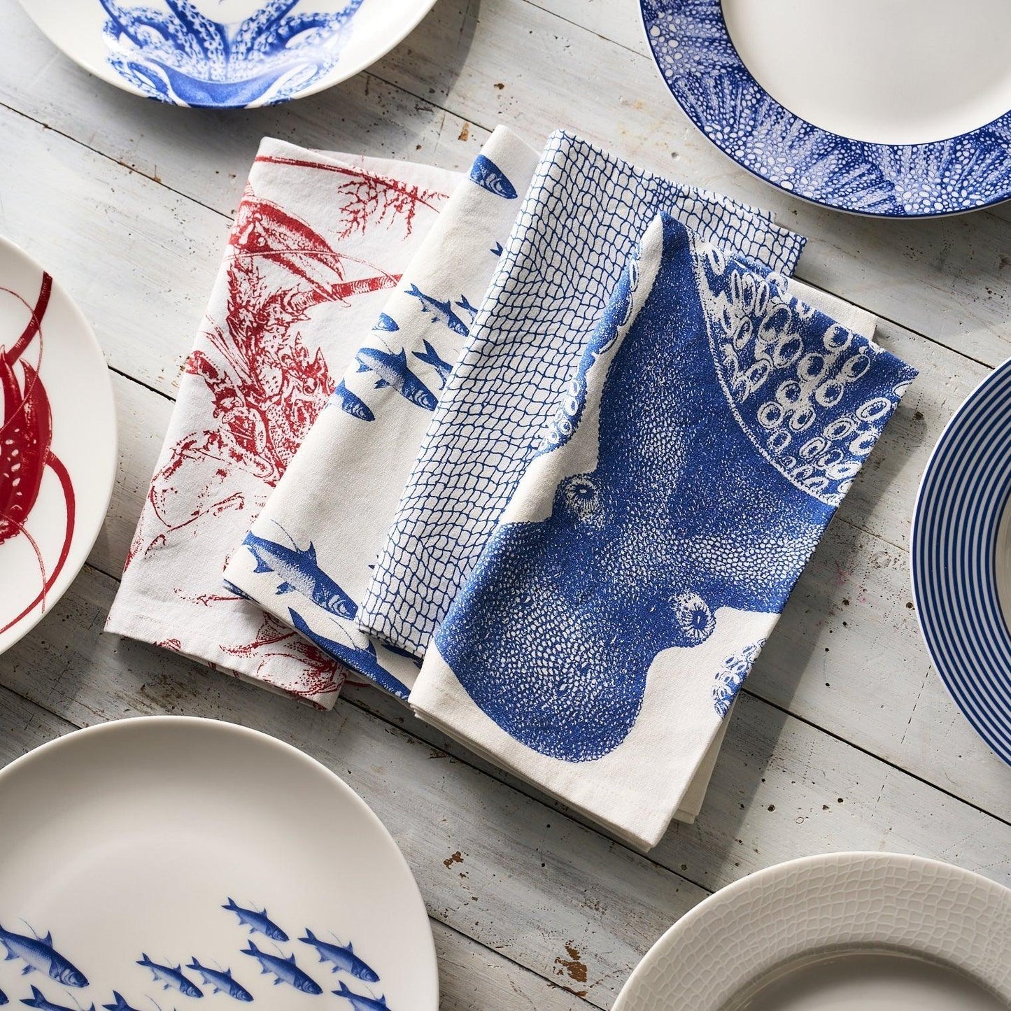 a table topped with blue and white plates