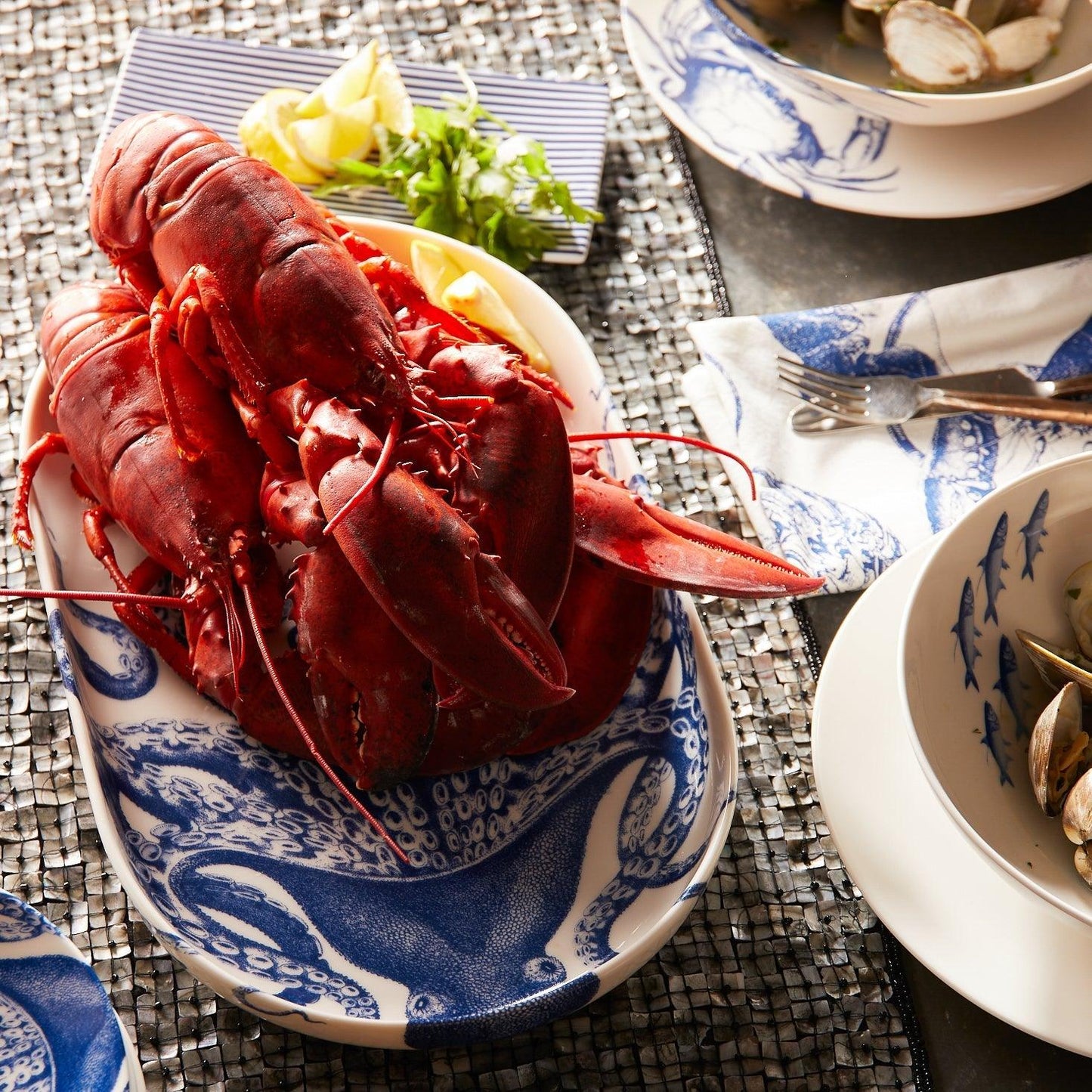 a plate of lobster and clams on a table