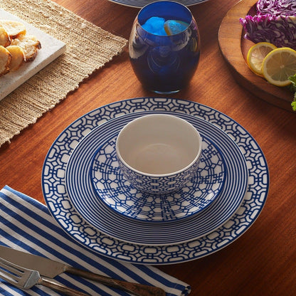 Newport Garden Gate blue small plate layered with striped and lattice-pattern dinnerware beneath a matching bowl