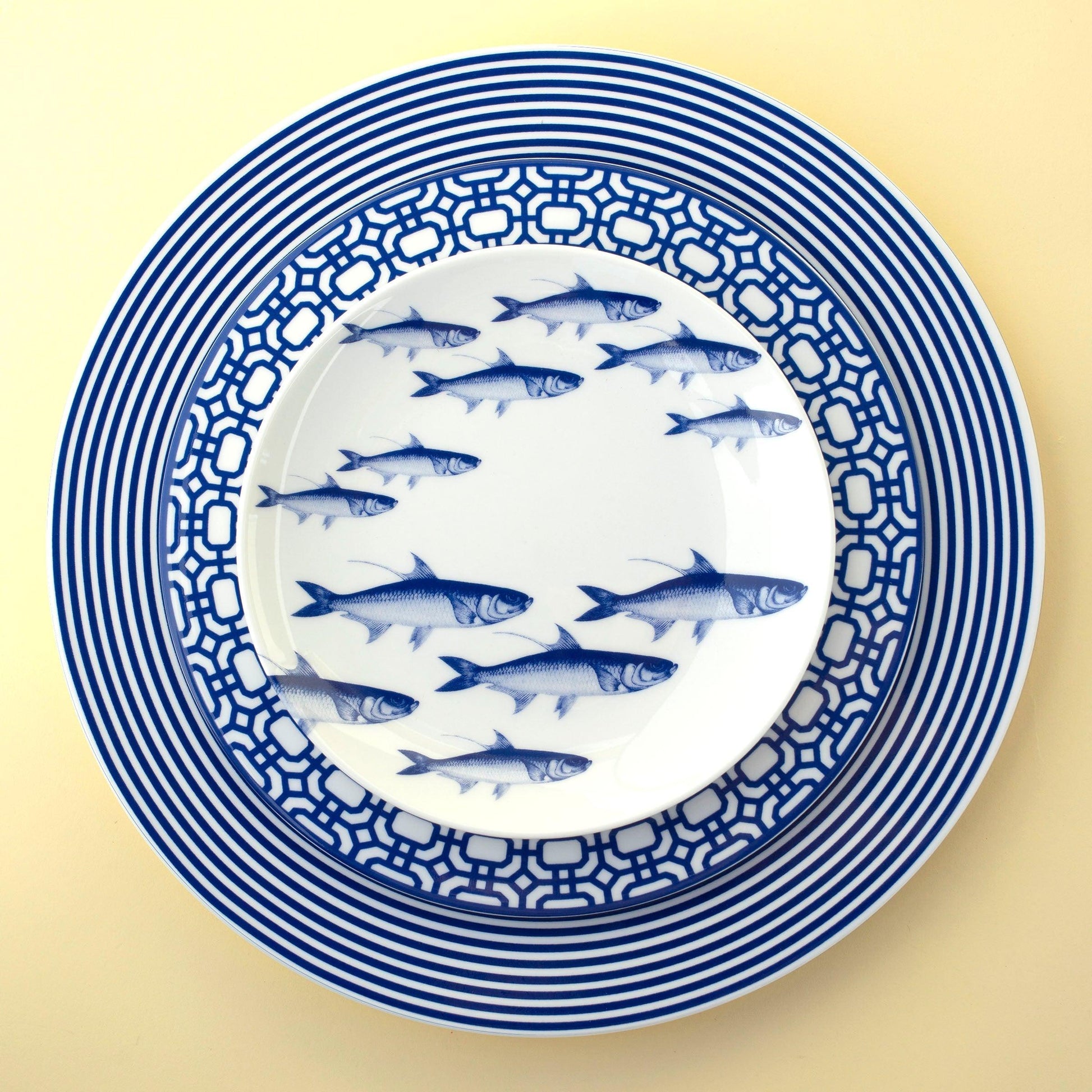 a blue and white plate with fish on it