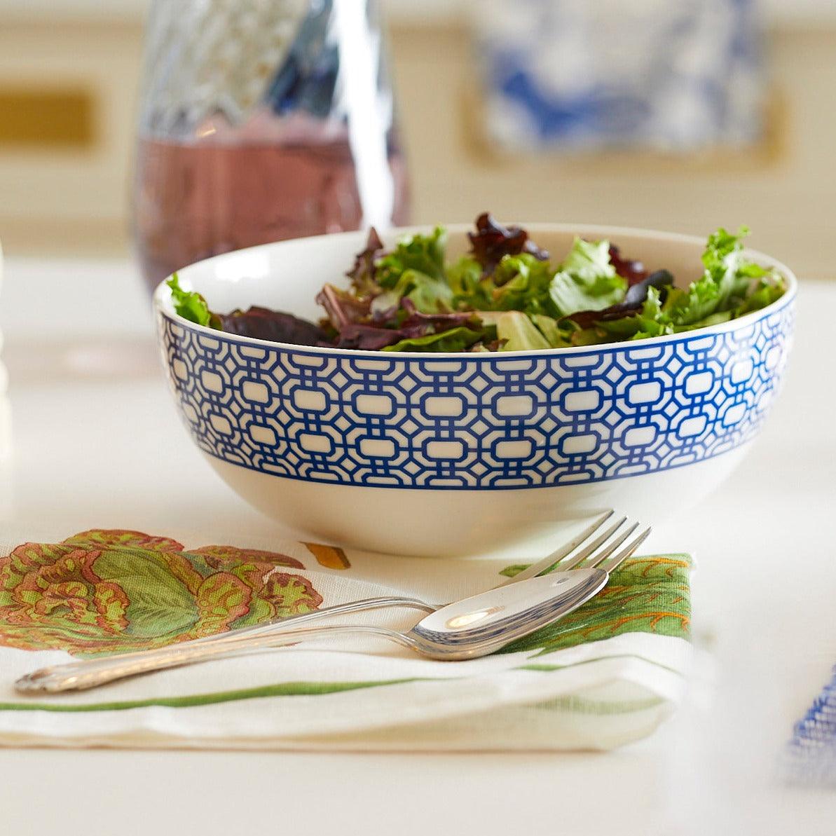 a bowl of salad on a table next to a glass of water