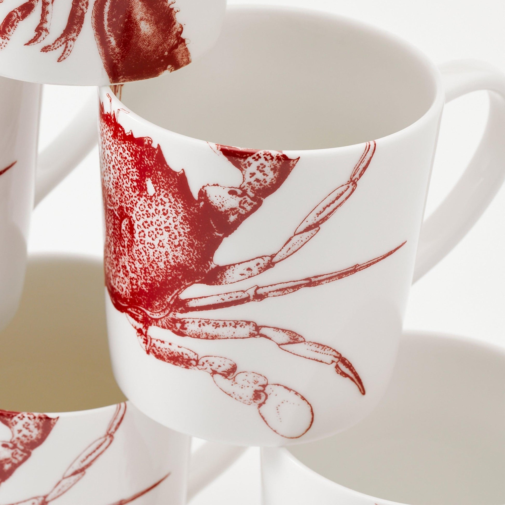 a group of coffee cups with red designs on them