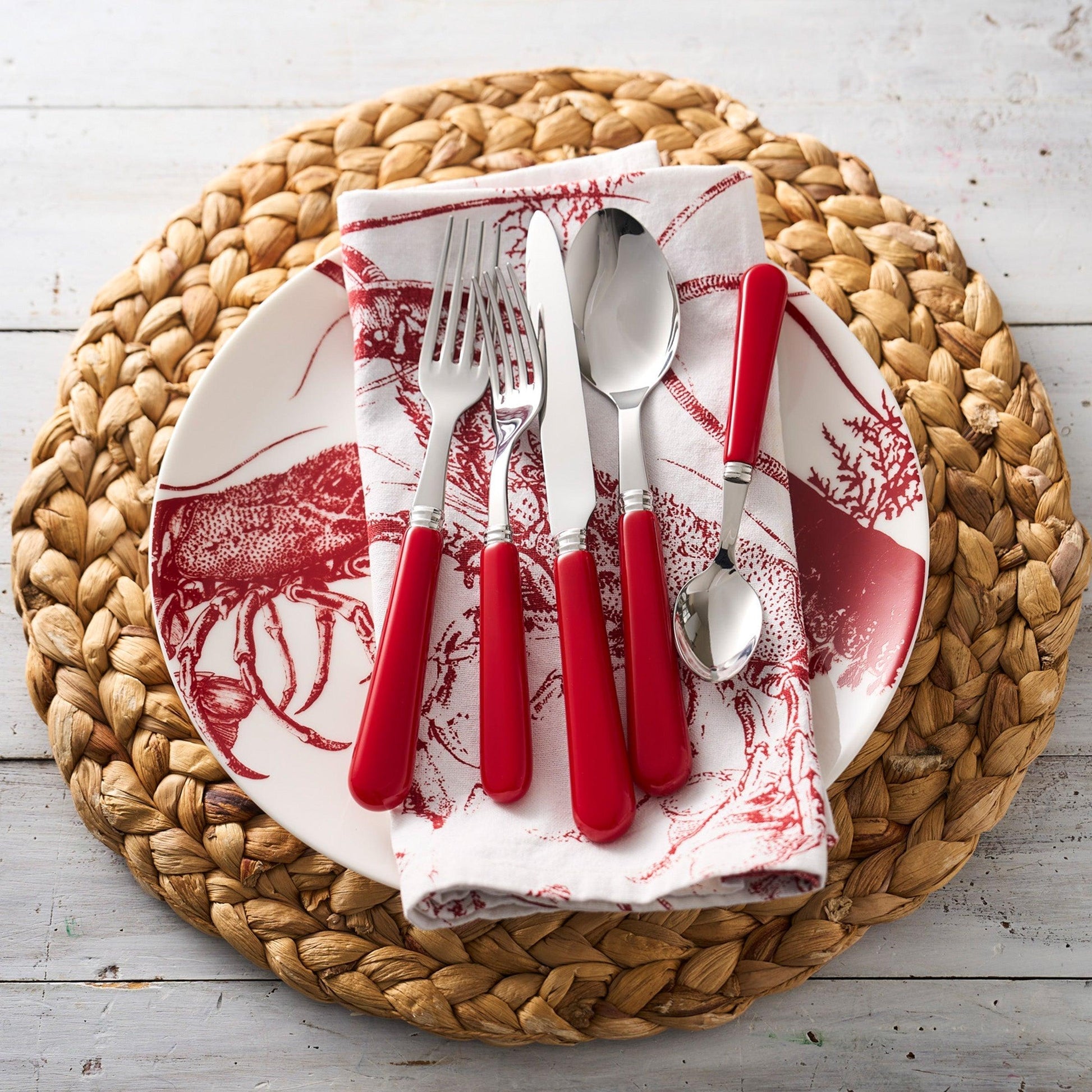 a plate with red utensils on it