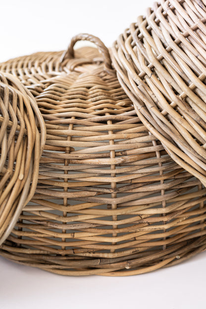 Close-up of the woven rattan sides and handles on grouped dome food covers