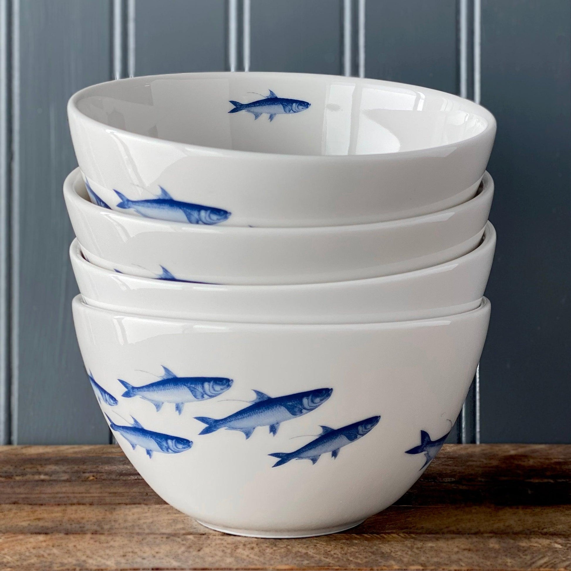 a stack of bowls with fish painted on them