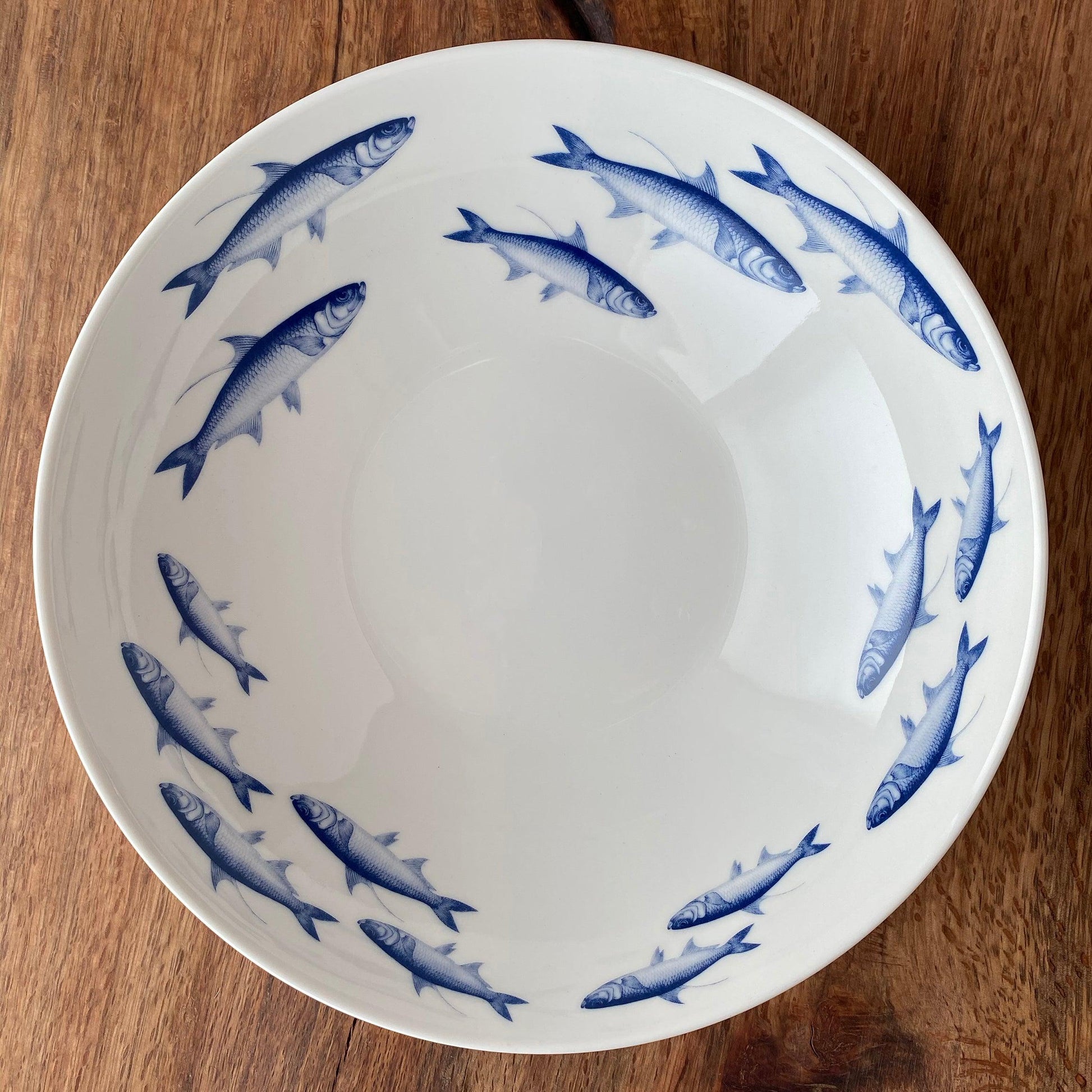 a blue and white bowl on a wooden table