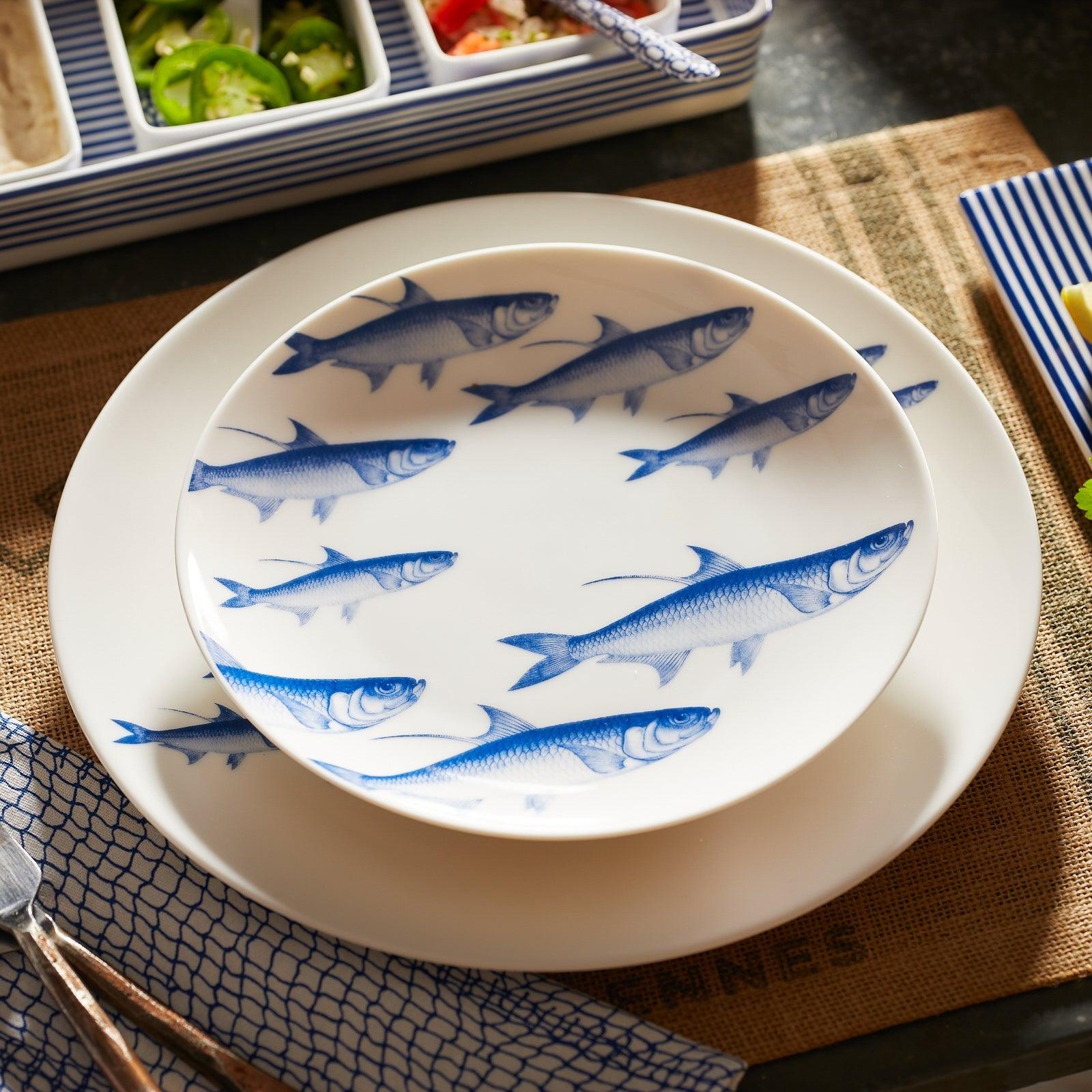 a blue and white plate with fish on it