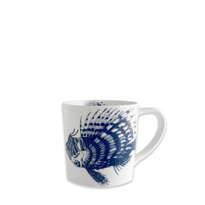 	Caskata Spiky Fish white porcelain mug with a detailed blue fish and matching artwork inside the rim