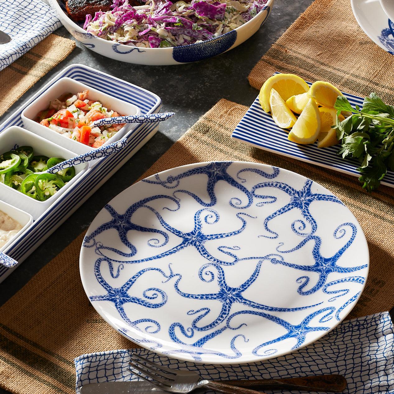 a table topped with plates of food and bowls of salad