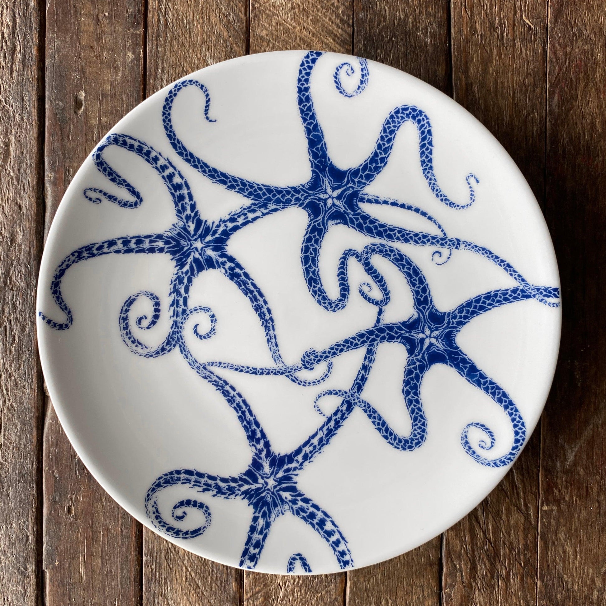 a blue and white plate with an octopus design on it