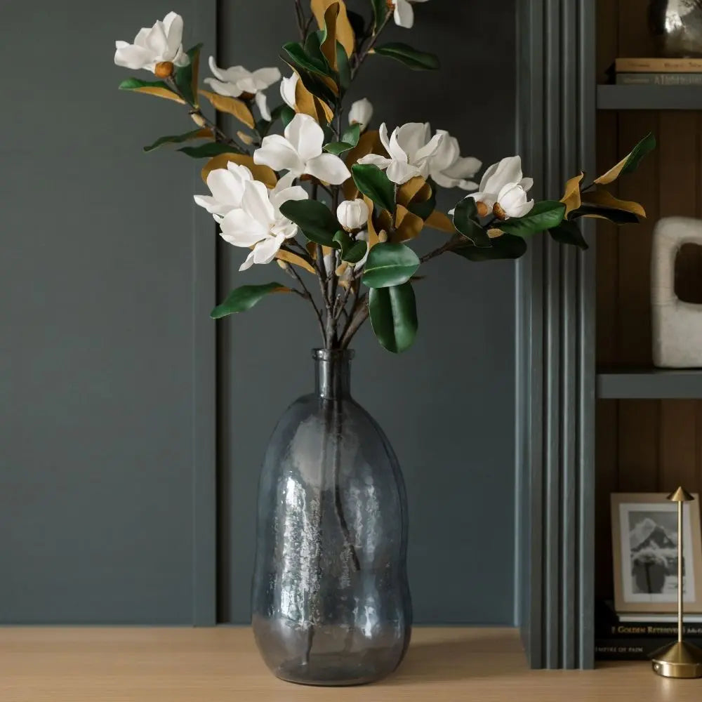 Close-up of textured hammered glass vase in smoke gray