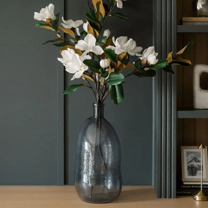 Close-up of textured hammered glass vase in smoke gray