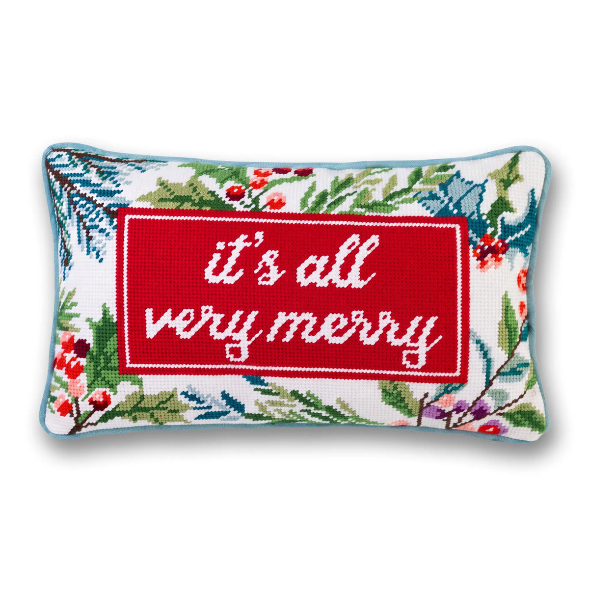 It’s All Very Merry needlepoint pillow with white lettering on red, a festive botanical border, and light blue piping