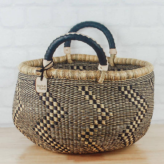 a woven basket sitting on top of a wooden table