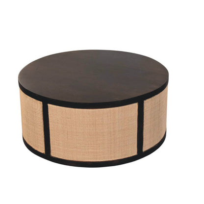 	Angled view of the Monaco drum coffee table showing its circular wood top and rattan sides